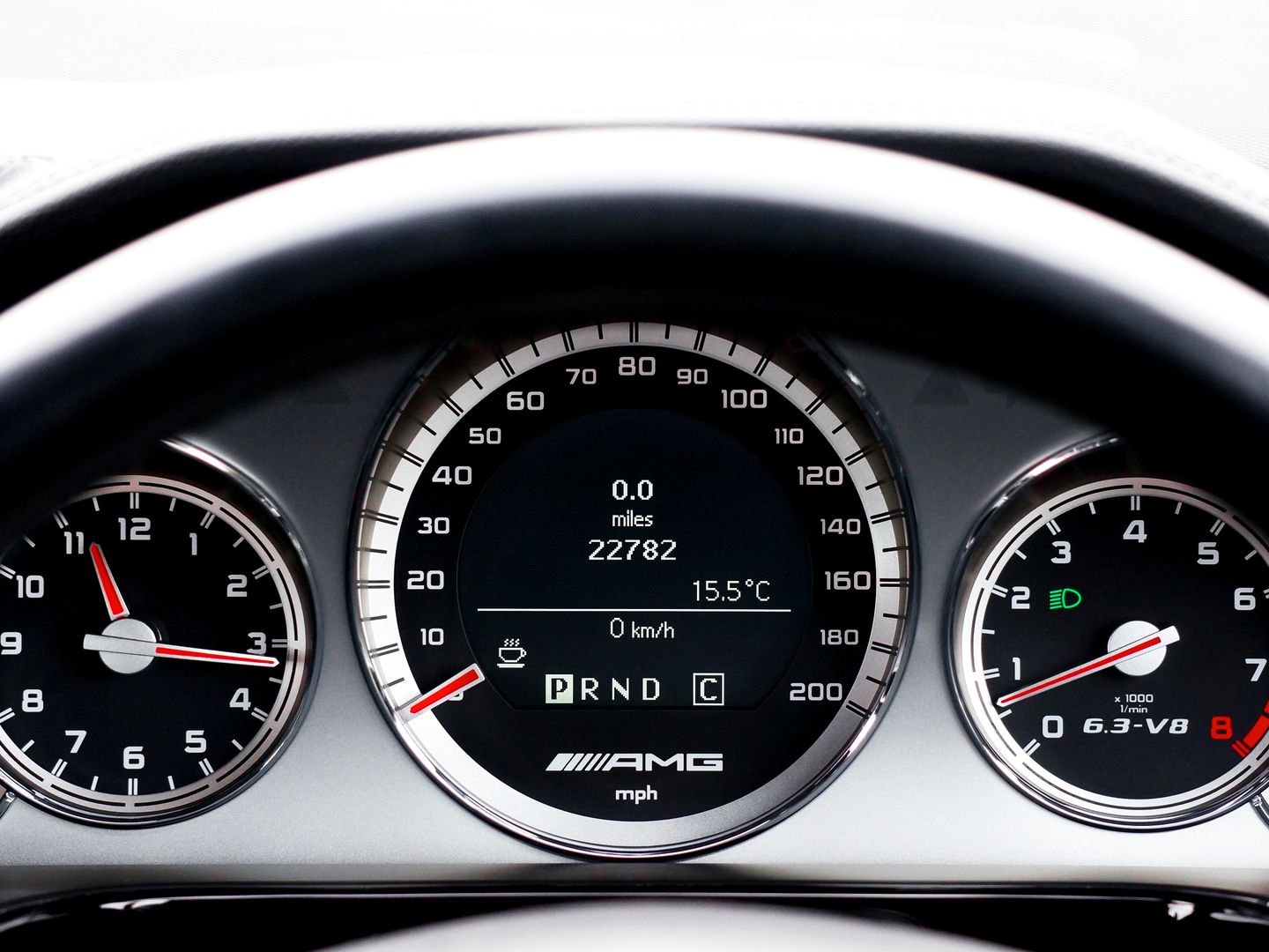 Detailed close up of a vehicle dashboard featuring modern speedometers and controls.